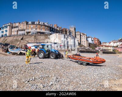 30 June 2019: Cromer, Norfolk, UK -  RNLI inshore lifeboat being pushed out on beach for launch during a training exercise. Stock Photo