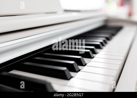 close-up of piano keys. close frontal view, black and white piano keys, viewed from side Stock Photo