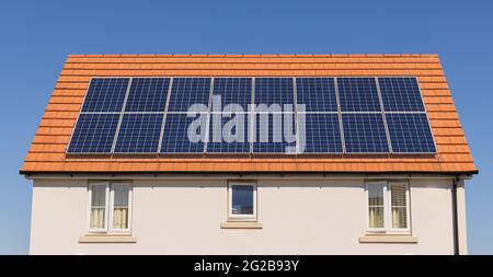 Solar panels on the roof a new build home.  UK Stock Photo