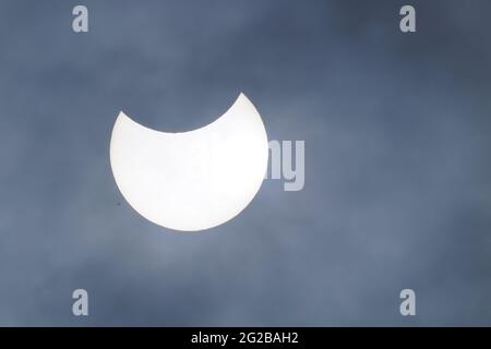 A partial solar eclipse as seen over Liverpool. The annular eclipse occurs when the sun and moon are exactly in line with the Earth, but the apparent size of the moon is smaller than that of the sun, causing the sun to appear as a very bright ring, or annulus. Picture date: Thursday June 10, 2021. Stock Photo