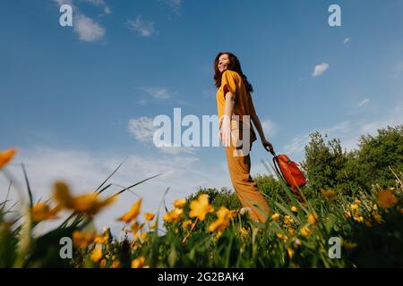 Happy girl walks in the summer meadow. Stock Photo