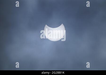 A partial solar eclipse as seen over Liverpool. The annular eclipse occurs when the sun and moon are exactly in line with the Earth, but the apparent size of the moon is smaller than that of the sun, causing the sun to appear as a very bright ring, or annulus. Picture date: Thursday June 10, 2021. Stock Photo