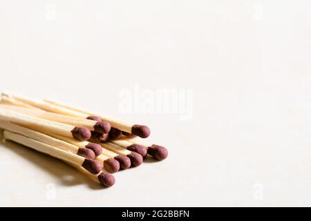 Matchsticks on white colored background to left side. Used selective focus. Stock Photo