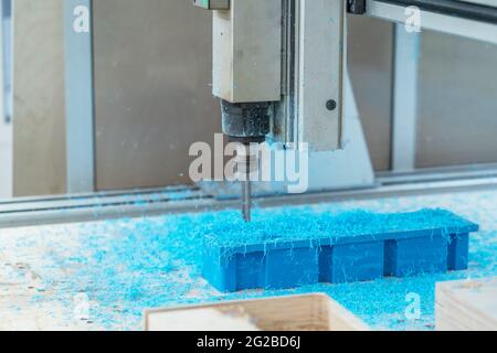 CNC drill machine cutting mold from plastic, close up. Stock Photo