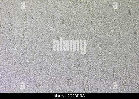 white textured background of filler paste applied with putty knife in irregular dashes and strokes Stock Photo