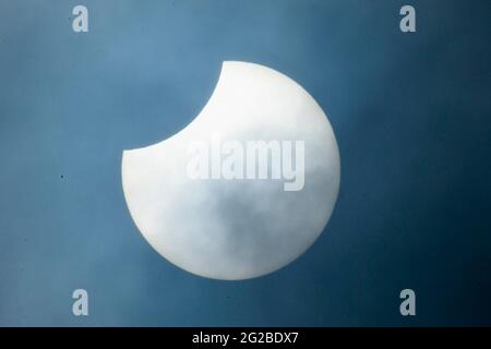 Crewkerne, Somerset, UK.  10th June 2021.  UK Weather.  The partial annular solar eclipse of the sun briefly breaks through the misty clouds above Crewkerne in Somerset.  Picture Credit: Graham Hunt/Ģ����ý Live News Stock Photo
