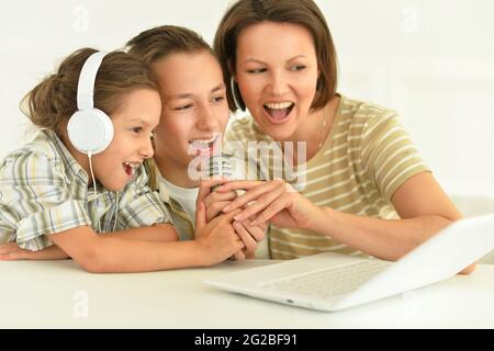 Mother with children using laptop singing karaoke Stock Photo - Alamy