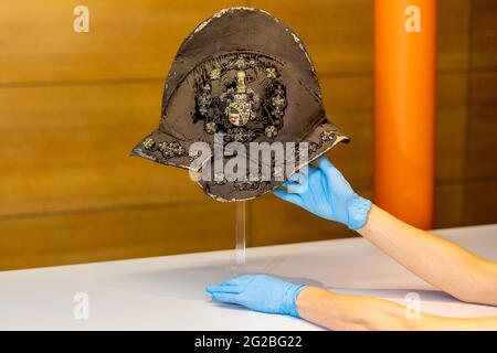 Hanover, Germany. 10th June, 2021. Maya Brockhaus, Project Team Moritz from Buxtehude, arranges a morion, an open helmet type without visor, from the clothing estate of Duke Moritz of Buxtehude (1551-1612). The Historisches Museum Hannover presents the clothing estate of the Duke of Saxe-Lauenburg. Credit: Moritz Frankenberg/dpa/Alamy Live News Stock Photo