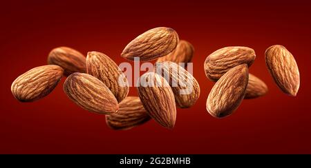 Almond isolated on dark red background, nuts collection, close up Stock Photo