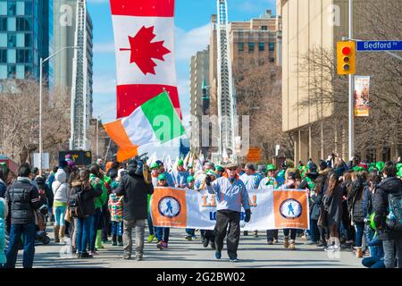 Irish flag along with Canadian flag during the St. Patrick's Day Parade 28th edition which is the fourth largest celebration of its kind in the world. Stock Photo