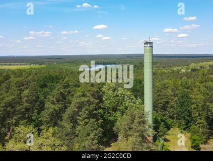 09 June 2021, Brandenburg, Zesch Am See: Radio technology and a camera are mounted on the roof of the fire watch tower 'Zesch' near Wünsdorf by the Brandenburg State Forestry Office (aerial view with a drone). With the rising temperatures, the danger of forest fires has increased in Brandenburg. Two forest fire centers in Wünsdorf (Teltow-Fläming) and Eberswalde (Barnim) monitor what is happening in the state. They are staffed from stage 3. Photo: Patrick Pleul/dpa-Zentralbild/ZB Stock Photo