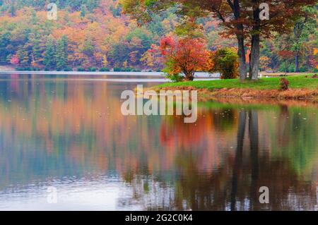 Calm lake reflecting autumn foliage in The Blue ridge mountains, Appalachia chain ,USA. Stock Photo