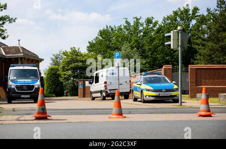 Hanover, Germany. 10th June, 2021. Emergency vehicles of the police stand before the beginning of the funeral of a murder victim at an entrance to the city cemetery Stöcken. On 03.06.2021 there was an altercation between occupants of two cars on an open street in Hanover, in the course of which a man was killed. Credit: Moritz Frankenberg/dpa/Alamy Live News Stock Photo