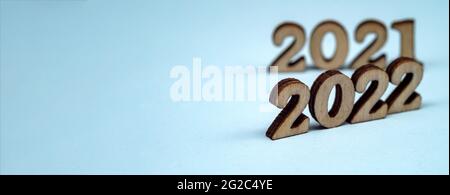 Banner 2022. Numerals 2022 on blue background. Wooden digits 2022. Stock Photo