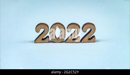 Banner 2022. Numerals 2022 on blue background. Wooden digits 2022. Stock Photo