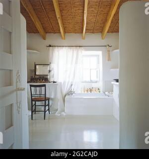 White bathroom with beamed ceiling Stock Photo