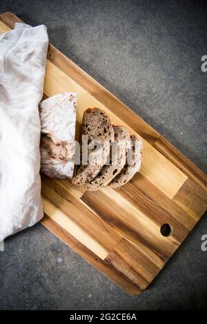 Sliced bread on wooden board Stock Photo