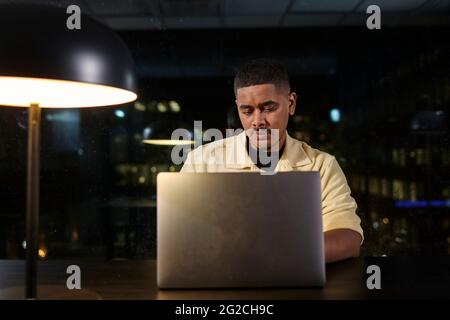 Man working late Stock Photo