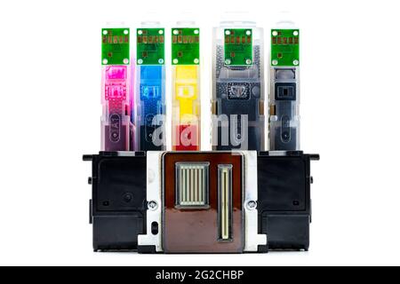 A close-up shot of a printer head and ink cartridges inserted into it, isolated on a white background. Stock Photo