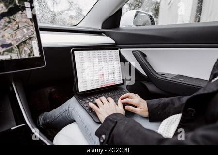 Woman in car using laptop Stock Photo