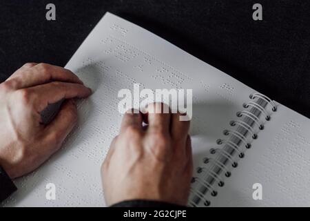 Man reading Braille book Stock Photo