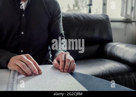 Man reading Braille book Stock Photo