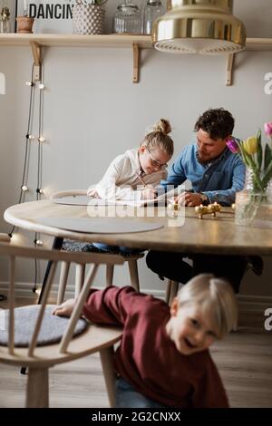 Father helping daughter doing homework Stock Photo