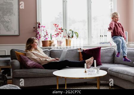 Mother with son on sofa Stock Photo