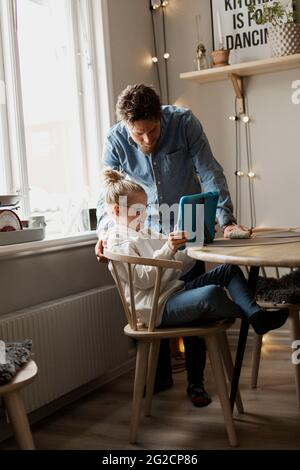 Father with daughter using digital tablet Stock Photo