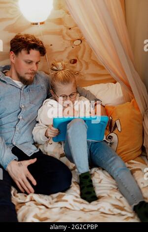 Father with daughter using digital tablet Stock Photo