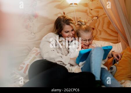 Mother with daughter using digital tablet Stock Photo