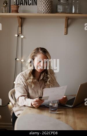 Woman reading documents at home Stock Photo