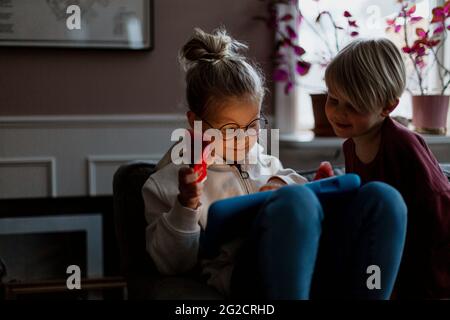 brother and sister using digital tablet Stock Photo