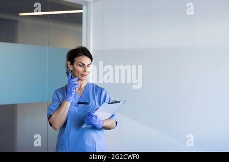 Female nurse talking on phone Stock Photo