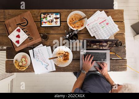High angle view of man using laptop Stock Photo