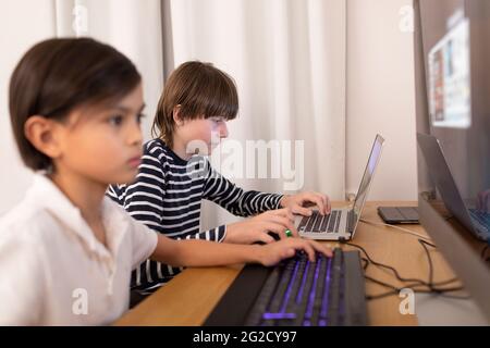 Boys using computers at home Stock Photo