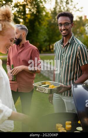 Friends having barbecue in garden Stock Photo