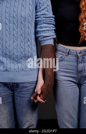 Mid section of couple holding hands Stock Photo
