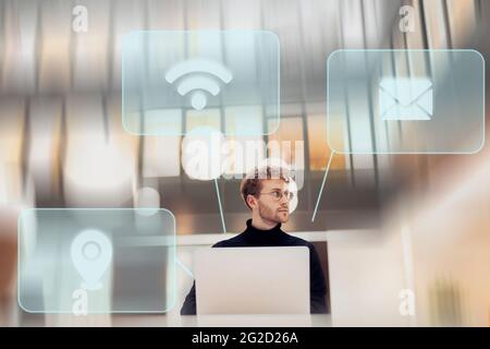 Young man using various services on laptop Stock Photo