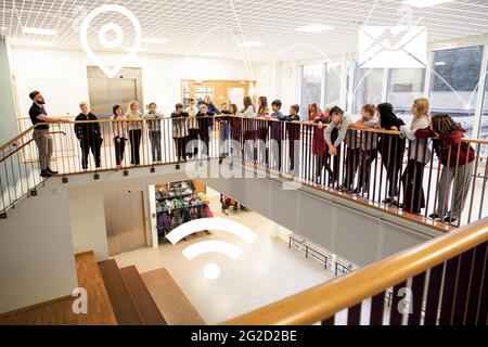Schoolchildren leaning over balustrade at school and various Internet services icons Stock Photo