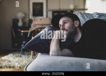 Mature man lying on sofa Stock Photo
