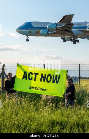 US President Joe Biden arriving RAF Mildenhall, Suffolk, UK, in Air Force One USAF Boeing VC-25A plane. Greenpeace protest banner for climate change Stock Photo