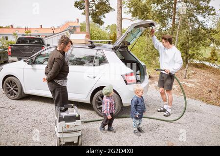 Man vacuuming car boot Stock Photo