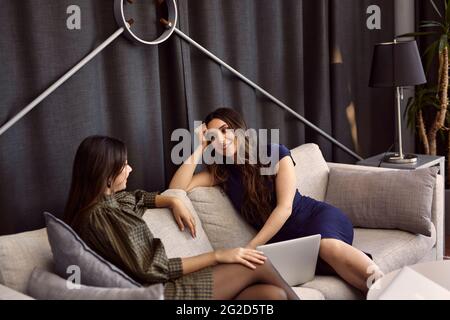 Businesswomen talking on sofa Stock Photo