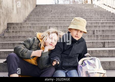 Children sitting on stairs Stock Photo