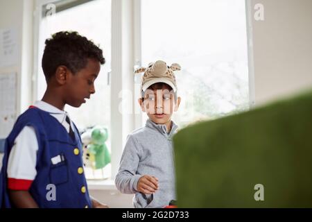 Boys talking in classroom Stock Photo