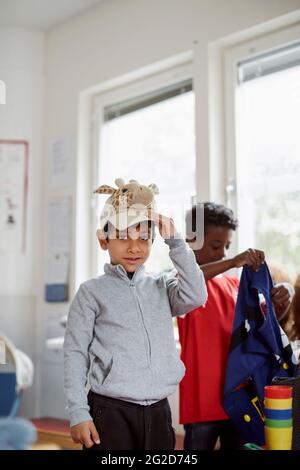Boy in classroom looking at camera Stock Photo