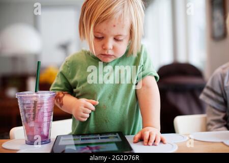 Girl playing with digital tablet Stock Photo