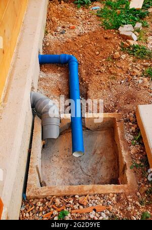 A partially contructed sewage inspection chamber for waste water from sinks, washing machine and toilet outside a house uder construction. Udine,Italy Stock Photo