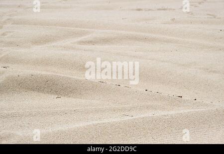 Sand texture background. Sandy beach rippled. Natural stone wavy closeup view. Summer vacation concept. Stock Photo